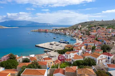 a view of a town with boats in the water at Villa Katingo in Halki