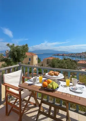 a wooden table with food on top of a balcony at Villa Katingo in Halki