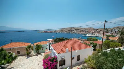 a view of a house and the water at Filoxenia Apartments in Halki