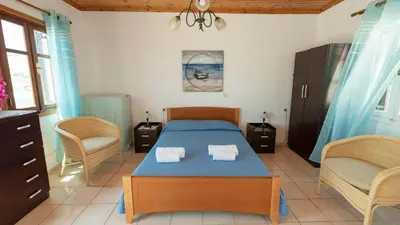 a bedroom with a bed with two towels on it at Filoxenia Apartments in Halki