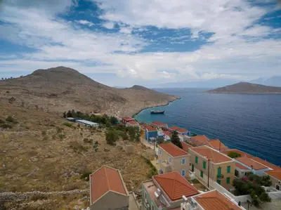 an aerial view of a village on a hill by the water at Filoxenia Apartments in Halki