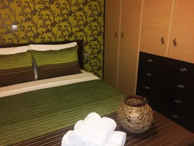 a bedroom with a bed with towels on it at Kima Stegna sea view in Archangelos