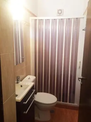 a bathroom with a toilet and a sink at Kima Stegna sea view in Archangelos