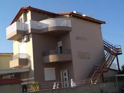a large white building with balconies on it at Colorful House (Attic) in Kremasti
