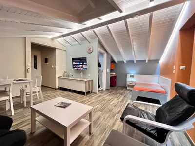 a living room with a couch and a table at Colorful House (Attic) in Kremasti