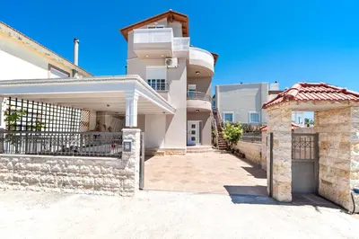 a house with a gate in front of it at Colorful House (Attic) in Kremasti