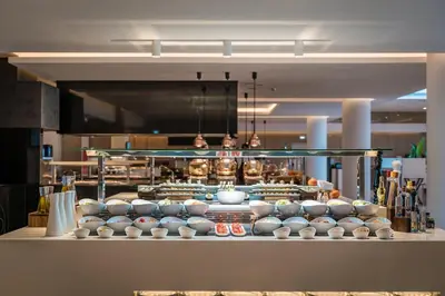 a kitchen with a bunch of bowls on display at Gennadi Grand Resort - Premium All Inclusive in Gennadi