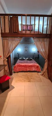 a bedroom with a canopy bed with a red comforter at Diasoulas house in Rhodes Town