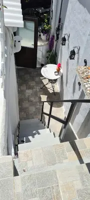 a patio with a table and a bench on a porch at Diasoulas house in Rhodes Town