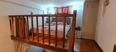 a bed in a room with a wooden railing at Diasoulas house in Rhodes Town