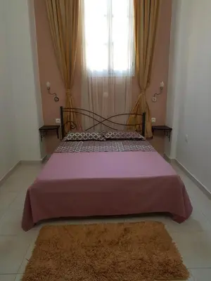 a large bed in a room with a window at Diasoulas house in Rhodes Town