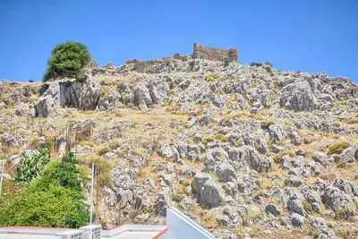 a castle on top of a rocky mountain at Haraki View in Haraki