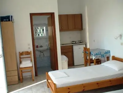 a small bedroom with a bed and a kitchen at Haraki View in Haraki