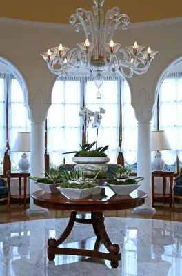 a dining room with a chandelier and a table at Grande Albergo Delle Rose in Rhodes Town