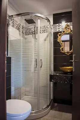 a bathroom with a shower with a toilet and a sink at Hotel Kalithea in Kallithea Rhodes