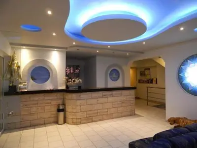 a lobby with a blue lights on the ceiling at Hotel Kalithea in Kallithea Rhodes