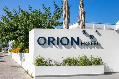 an orion hotel sign in front of a building at Orion Hotel in Faliraki