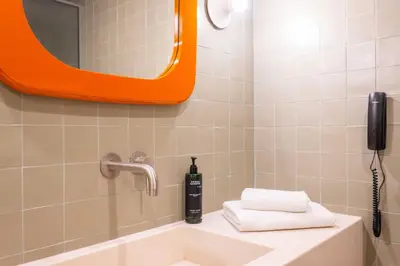 a bathroom with a sink and a mirror at Orion Hotel in Faliraki
