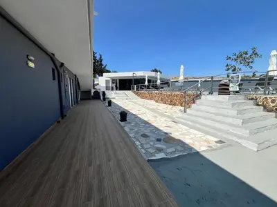 a walkway leading up to a building with stairs at Family House Faliraki Studios Apartments in Faliraki