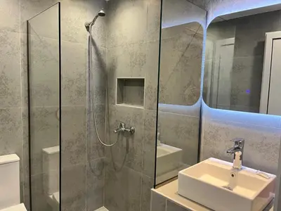 a bathroom with a sink and a glass shower at Family House Faliraki Studios Apartments in Faliraki