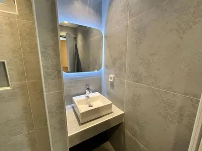 a bathroom with a sink and a mirror at Family House Faliraki Studios Apartments in Faliraki