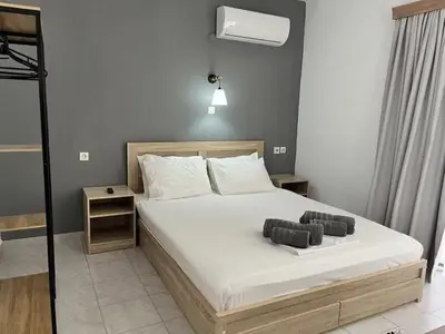 a bedroom with a bed with two pillows on it at Family House Faliraki Studios Apartments in Faliraki