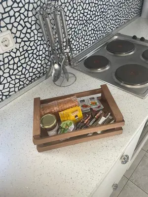 a wooden tray filled with food on a kitchen counter at Estella’s House in Livadia