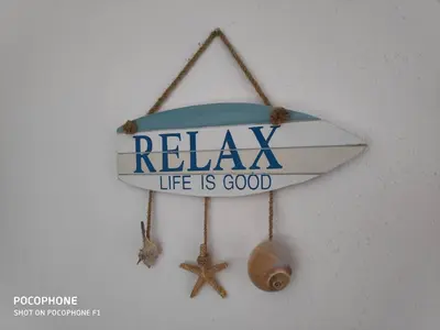 a sign that says relax life is good with a starfish at Estella’s House in Livadia
