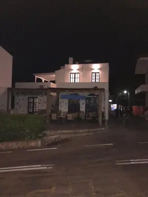 a white house at night with a building at Estella’s House in Livadia