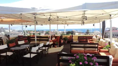 a patio with tables and chairs on a roof at Minos Pension in Rhodes Town
