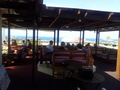a group of people sitting on a bench in a restaurant at Minos Pension in Rhodes Town