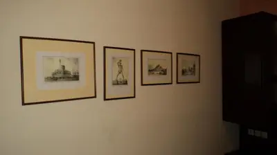 a group of pictures hanging on a wall at Minos Pension in Rhodes Town
