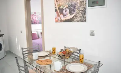 a glass table with plates of food on it at Levande Studio with private parking in Afantou