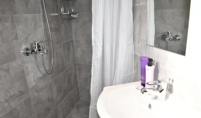 a bathroom with a shower and a sink and a shower at Levande Studio with private parking in Afantou