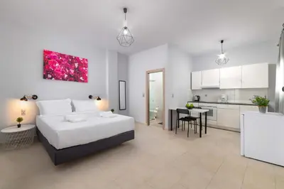 a bedroom with a large bed and a kitchen at Ble Azzure in Gennadi