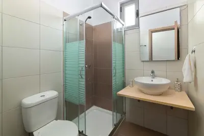 a bathroom with a toilet and a sink and a shower at Ble Azzure in Gennadi