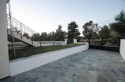 a patio with a staircase and a fence at Butterfly Estates Maritsa Rhodes in Pastida