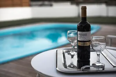 a bottle of wine sitting on a table with two glasses at Butterfly Estates Maritsa Rhodes in Pastida