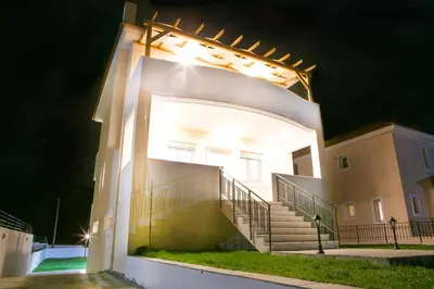 a white building with stairs on it at night at Butterfly Estates Maritsa Rhodes in Pastida