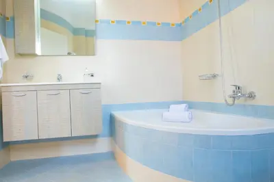 a bathroom with a tub and a sink and a mirror at Butterfly Estates Maritsa Rhodes in Pastida