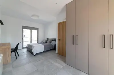 a bedroom with a bed and a desk at Aegean Treasure Pefkos in Pefki Rhodes