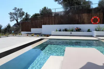 a pool in the backyard of a house at Lindian Jewel Hotel and Villas in Líndos