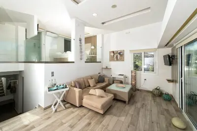 a living room with a couch and a table at Lindian Jewel Hotel and Villas in Líndos