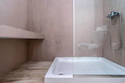 a bathroom with a shower and a tub with a toilet at Raffaello Beach in Faliraki