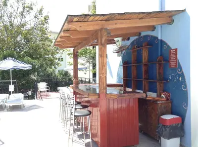 a restaurant with a bar with a wooden structure at Arte Annapolis Inn in Rhodes Town