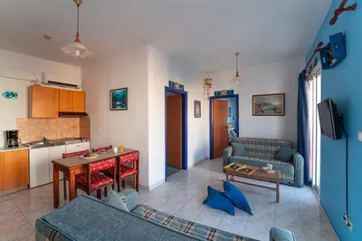 a living room with a couch and a table at Arte Annapolis Inn in Rhodes Town