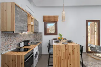 a kitchen with a wooden counter top and a stove at Alley 7, Old Town in Rhodes Town