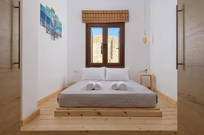 a bedroom with a bed with two towels on it at Alley 7, Old Town in Rhodes Town