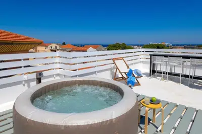 a hot tub on the roof of a house at Alley 7, Old Town in Rhodes Town