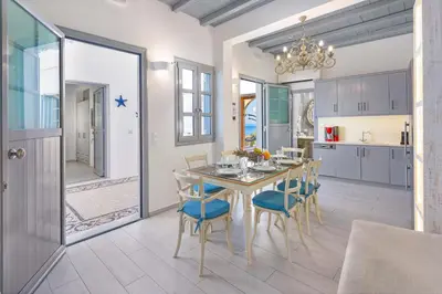 a kitchen and dining room with a table and chairs at Lindos Shore Boutique Villa with sea view in Líndos